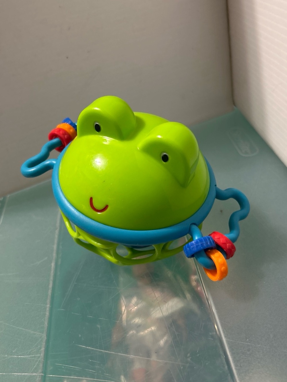 Bright Green Frog Sensory Rattle Toy with Blue Handle